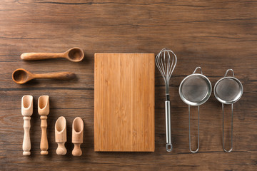Cutting board and kitchen utensils on wooden background. Cooking master classes