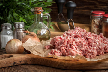 Minced meat on wooden background.