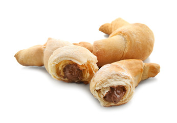 Tasty crescent rolls with chocolate on white background