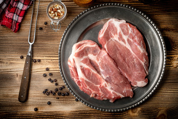 Slices of raw pork neck.