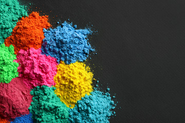 Colorful powders for Holi festival on dark background