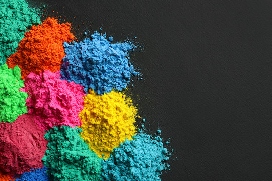 Colorful powders for Holi festival on dark background
