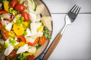 Salad with cheese and fresh vegetables.