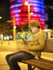Teenage boy typing text message.Using smart phone.Dusk.Selective focus © lado2016