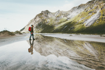 Man walking alone at sandy beach in mountains Travel lifestyle emotional concept adventure outdoor...