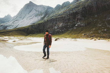 Tourist Man walking alone in mountains Travel lifestyle wanderlust concept adventure outdoor summer vacations wild nature