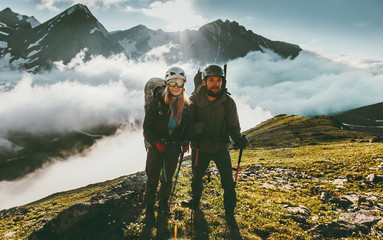 Obraz premium Traveling Couple climbing together in mountains love and adventure Lifestyle wanderlust friendship concept outdoor.