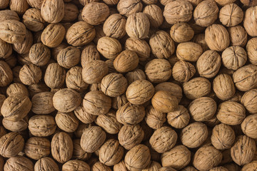 Background of walnuts close up. A full source of vegetable protein in vegetarianism and raw food. Concept - healthy eating.