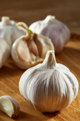 Garlic close up on rustic wooden background, shallow depth of field, selective focus, macro