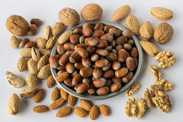 Different types of nuts . A full source of vegetable protein in vegetarianism and raw food. Assorted walnuts, almonds and hazelnuts. Concept - healthy eating.