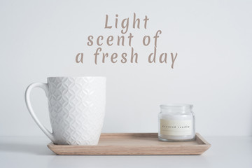 Bamboo tray with white coffee mug and scented candle