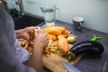 Young woman cooking in her modern kitchen (shallow DOF; color toned image)