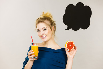 Happy woman holding fresh orange juice