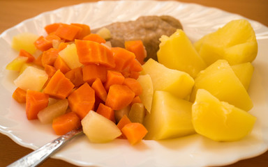 Dinner meal, braised carrot, boiled potatoes and meat