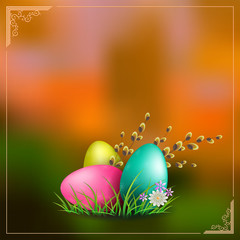 orange background with easter eggs with green grass and a branch of willow