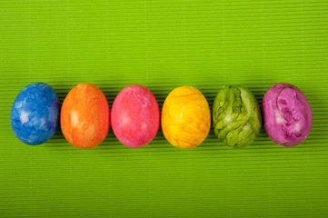 Easter colorful eggs over simple green background  with copy space 