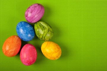 Easter colorful eggs over simple green background  with copy space 