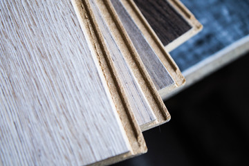 Samples of laminate and parquet board. Selection and types of floor coverings.