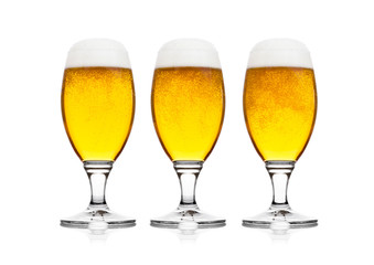 Cold glasses of lager beer with foam and dew