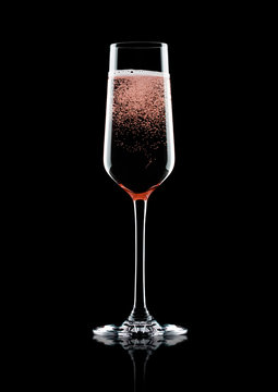 Rose pink champagne glass with bubbles on black