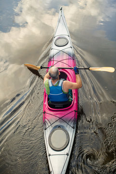  man riding a  kayak on a lake, top view