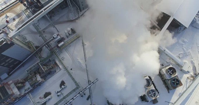 Aerial view of gas processing plant at winter time. Aerial view of factory smoke stack - Oil refinery, petrochemical or chemical plant in winter