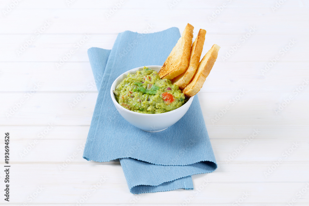 Poster bowl of guacamole with toast