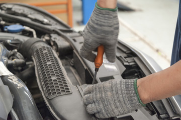 Hands of mechanic working in auto repair shop