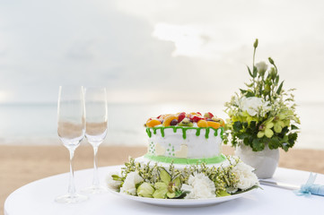 wedding cake and champagne wine glass on beach