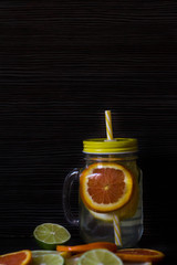 lemon, orange and lime on a black background