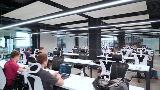 People work in spacious office.