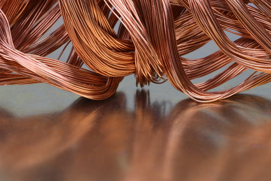Copper wire raw materials and metals industry closeup on metal background
