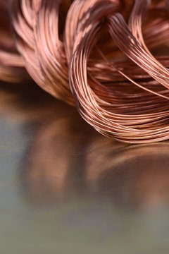 Closeup of Copper Wire on Metal Surface with Reflection