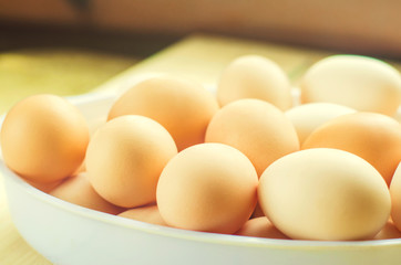 white and brown fresh chicken eggs in a plate. concept of easter.