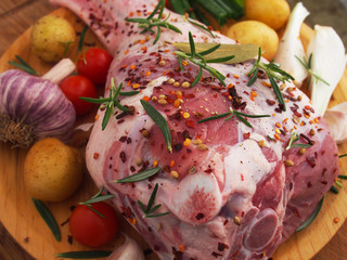 Fresh and raw meat. Leg of lamb on wood background