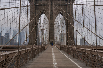 Fototapeta na wymiar Brooklyn Bridge and New York City Manhattan skyline on the background on moody morning