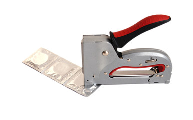 tape of three condoms lies on a white background, a construction stapler pierces one of them