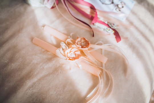 Beautiful set of women's wedding accessories. Bride's morning. Pink shoes.  Candles in powder color.