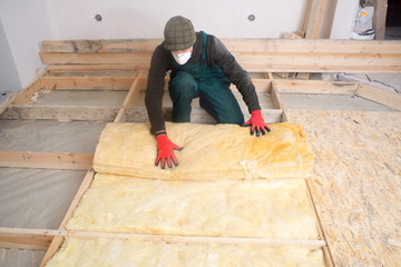 Work composed of mineral wool insulation in the floor, floor heating insulation , warm house,...