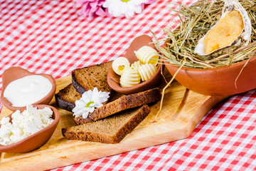 Appetizer. Toasted bread, butter, ricotta cheese, sour cream, caviar on wooden board
