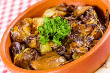 Fried forest mushrooms with potato in ceramic bowl