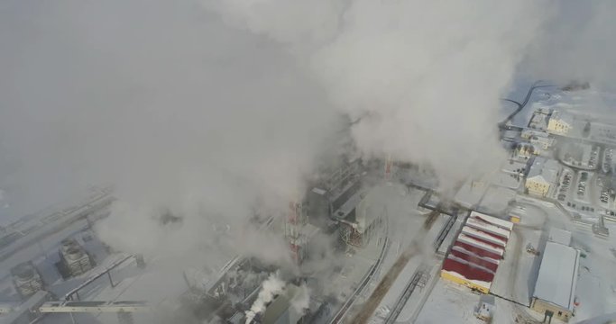 Aerial view of gas processing plant at winter time. Aerial view of factory smoke stack - Oil refinery, petrochemical or chemical plant in winter