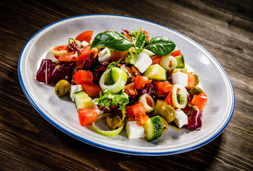 Greek salad on wooden background 