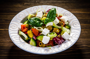 Greek salad on wooden background 