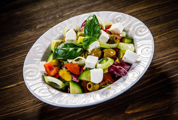 Greek salad on wooden background 