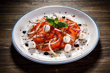 Caprese salad on wooden table