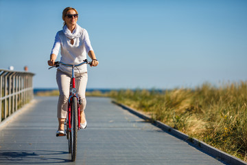 Woman riding bike outdoor © Jacek Chabraszewski
