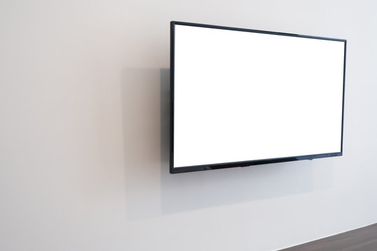 White blank screen television on concrete wall at living room. copy space for text on TV.