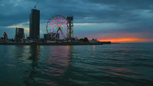 View from sea at landmarks in Batumi, Alphabetic Tower and observation wheel