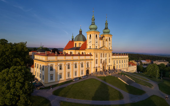 Aerial view on Pilgrimage Church of the Visitation of the Virgin Mary - pilgrimage site of European significance "The Holy Hill", from-afar visible silhouette of basilica minor against blue sky.